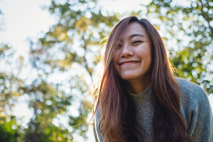 Portrait image of a beautiful asian woman standing among nature