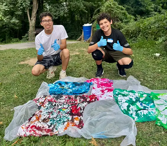 members of the FPC Coalition create tie-dye shirts that say Carry Narcan